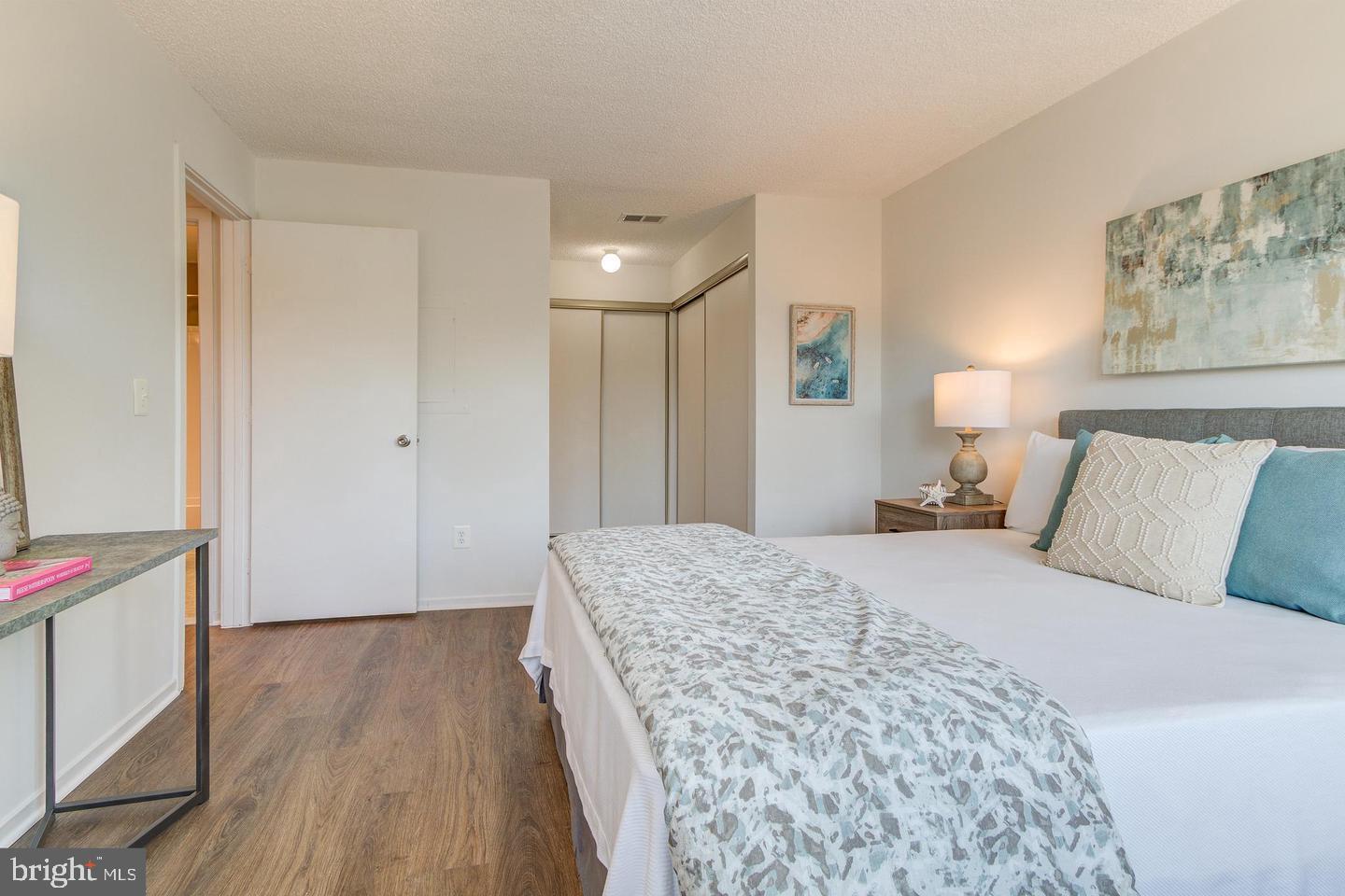 11707 D Summerchase Circle Reston, VA 20194 - Photo 16 of 21 a bedroom with a bed and a chandelier