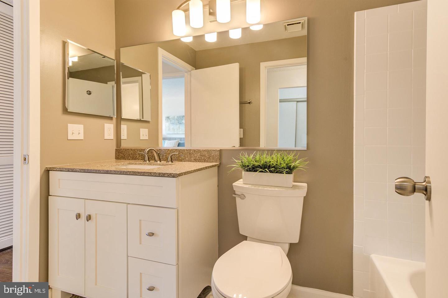 11707 D Summerchase Circle Reston, VA 20194 - Photo 20 of 21 a bathroom with a toilet sink and mirror