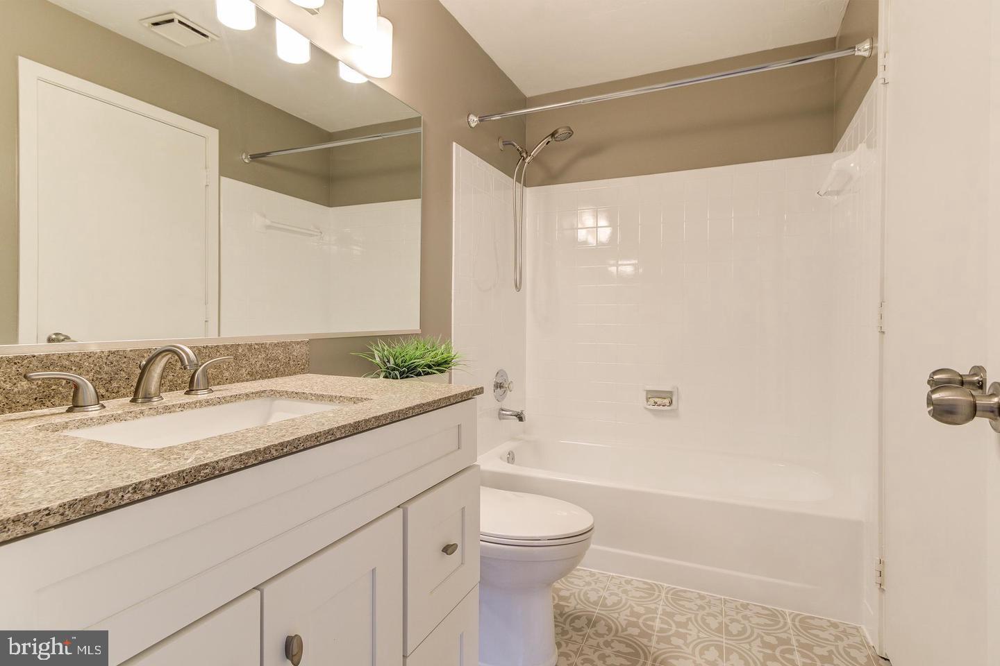 11707 D Summerchase Circle Reston, VA 20194 - Photo 21 of 21 a bathroom with a granite countertop sink toilet and shower