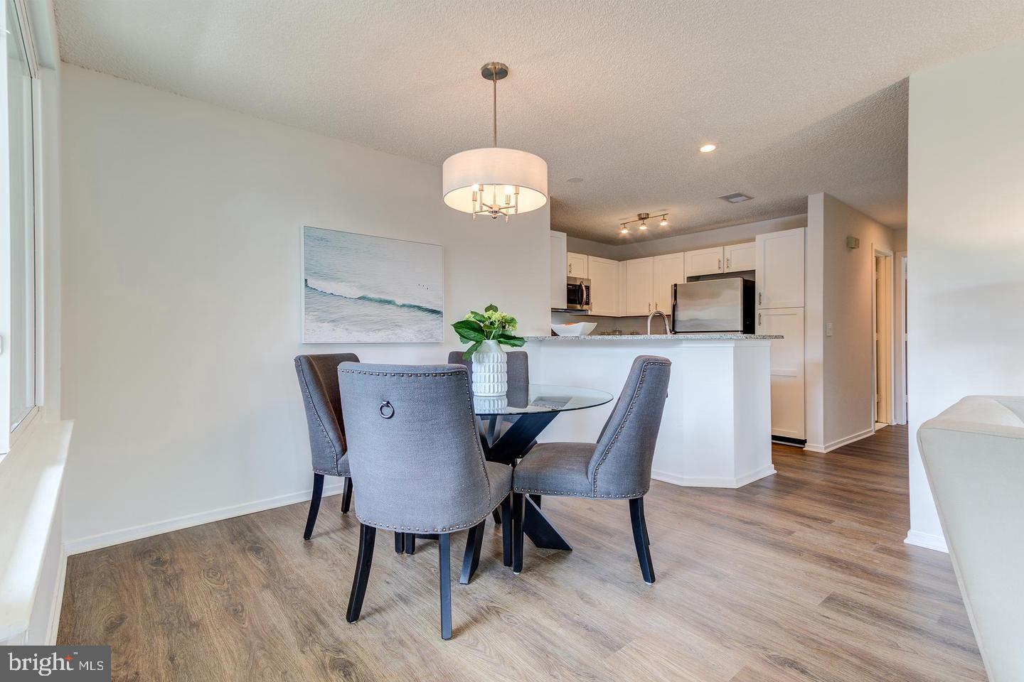 11707 D Summerchase Circle Reston, VA 20194 - Photo 6 of 21 a view of a dining room with furniture wooden floor and chandelier