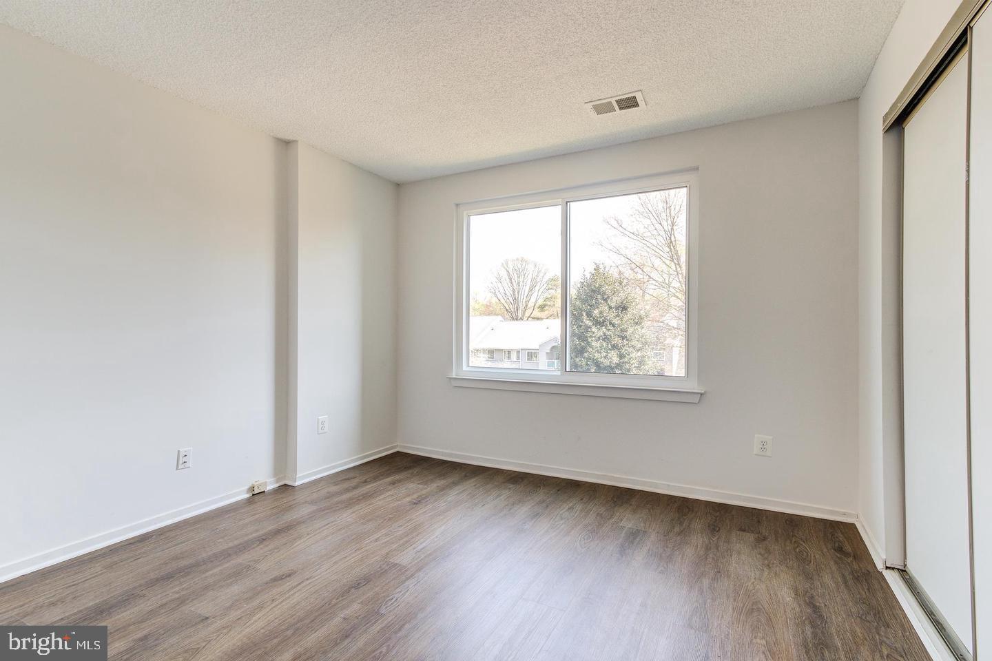 11707 D Summerchase Circle Reston, VA 20194 - Photo 10 of 21 an empty room with wooden floor and windows