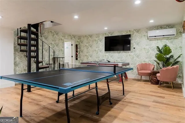 a living room with furniture a flat screen tv and kitchen view