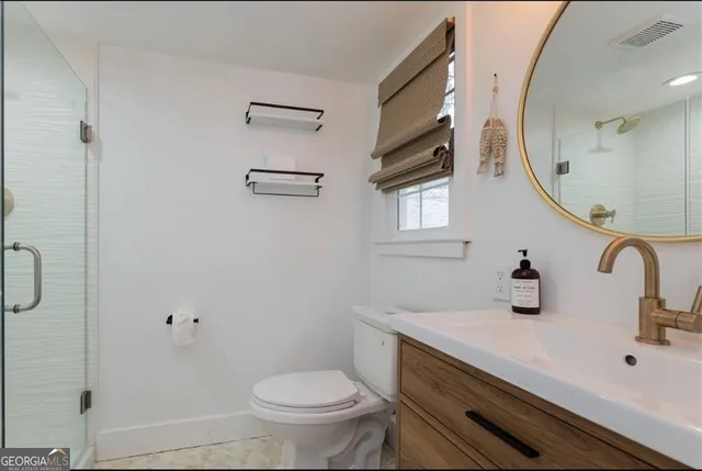 a bathroom with a sink a toilet and a mirror