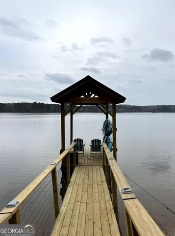 a view of a dinning table and chairs in patio of the house