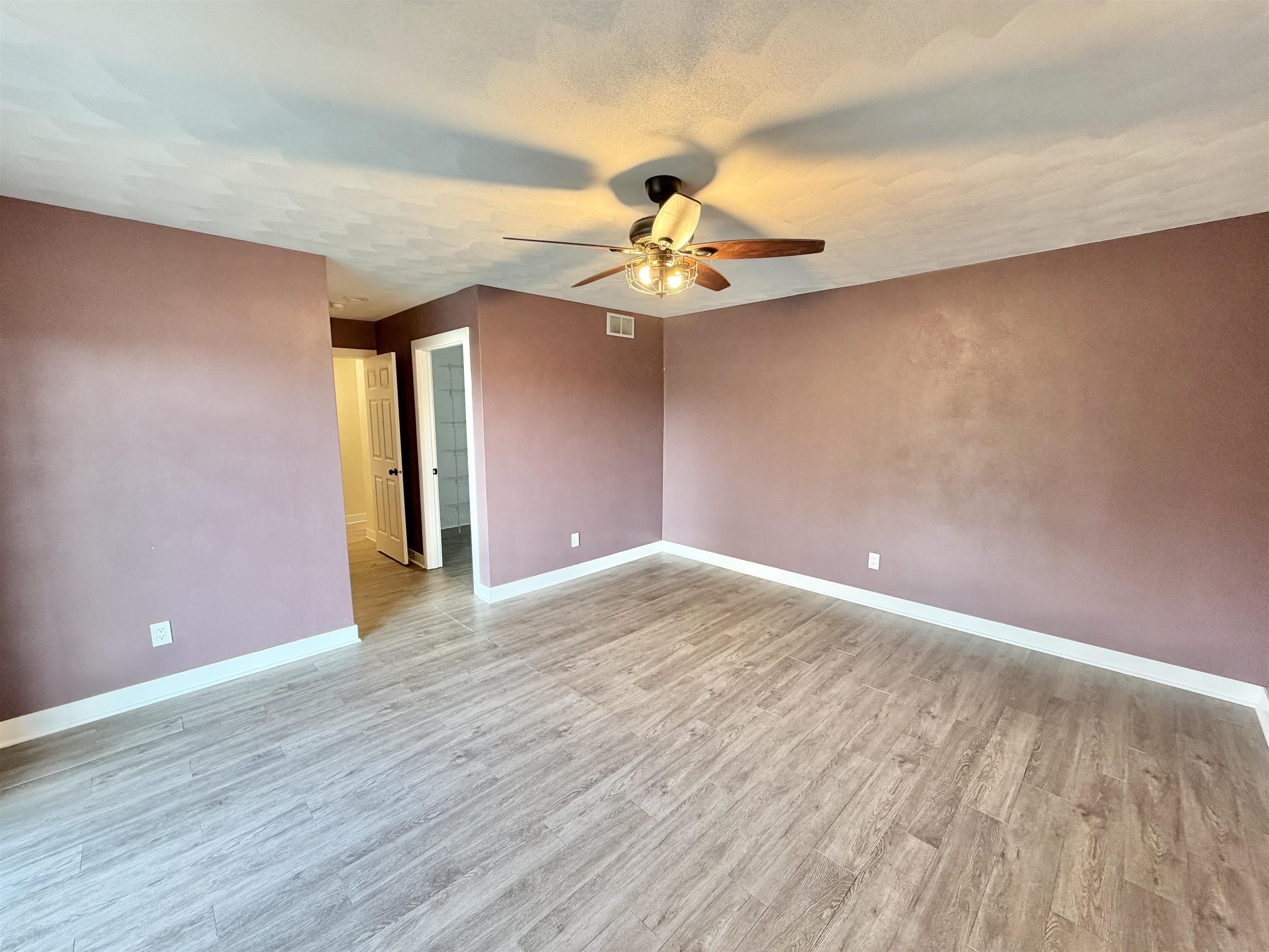 423 West 4th Street Byron, IL 61010 - Photo 15 of 31 a view of a livingroom with a chandelier fan and wooden floor