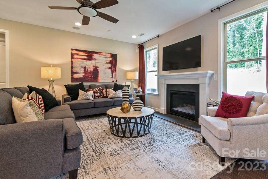 13220 Chopin Ridge Road Huntersville, NC 28078 - Photo 14 of 29 a living room with furniture a flat screen tv and a fireplace