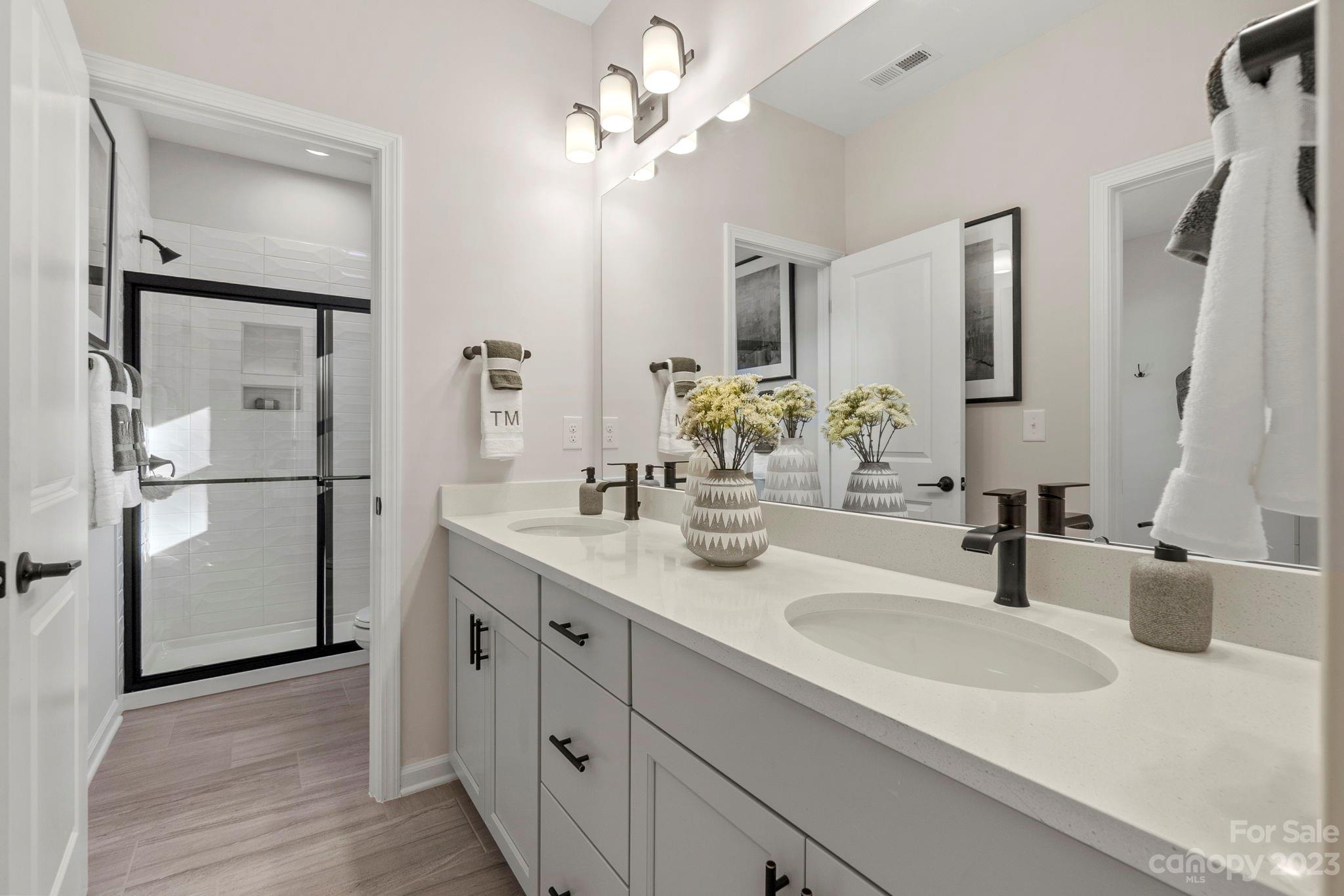 13220 Chopin Ridge Road Huntersville, NC 28078 - Photo 17 of 29 a bathroom with a sink double vanity and a mirror