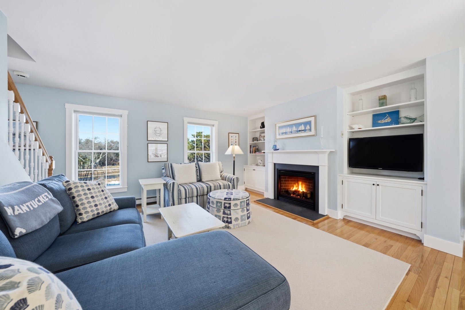 20 Rudder Lane Nantucket, MA 02554 - Photo 6 of 34 a living room with furniture a flat screen tv and a fireplace