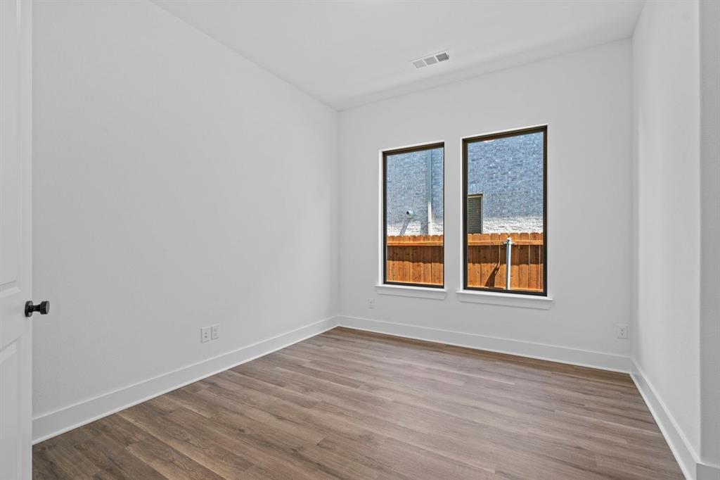 1792 Monarch Way Oak Point, TX 75068 - Photo 20 of 26 a view of an empty room with wooden floor and a window