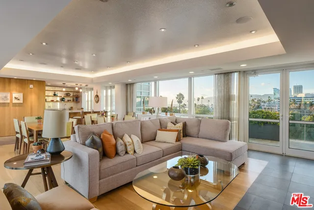 a kitchen with a dining table chairs sink and stove