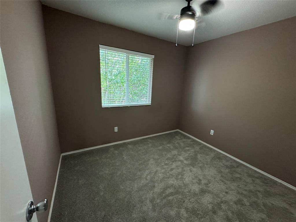 3200 Crownover Street Austin, TX 78725 - Photo 19 of 23 A well-lit bedroom awaits, complete with a ceiling fan for comfort.
