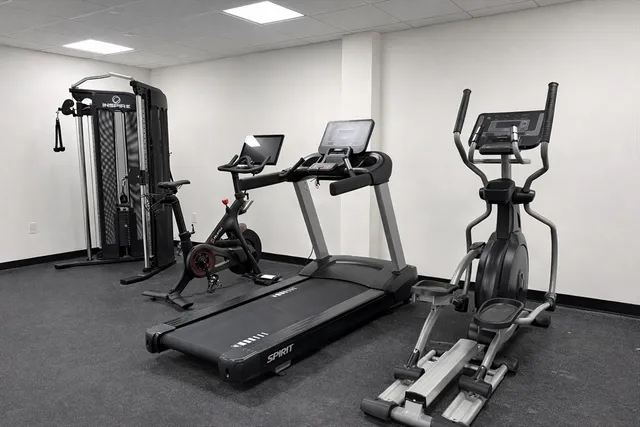 a room with gym equipment and windows