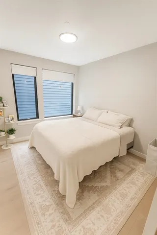 a bedroom with a bed and with wooden floor