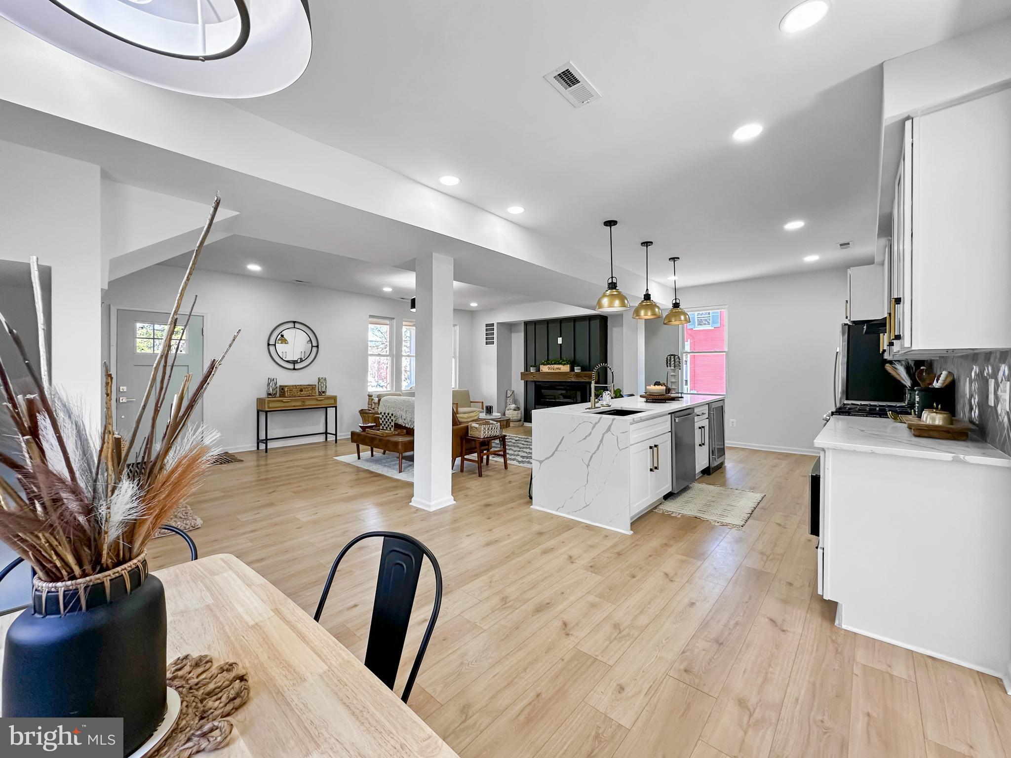 4309 Queensbury Road Riverdale, MD 20737 - Photo 12 of 63 a living room with furniture a dining table and kitchen view