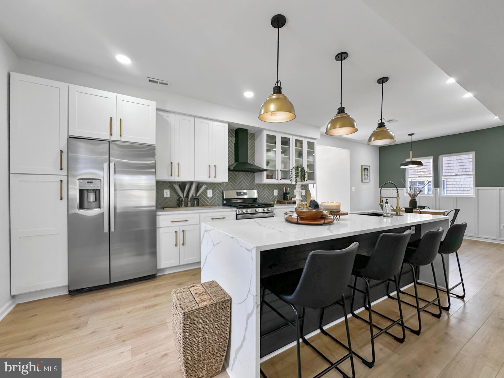 4309 Queensbury Road Riverdale, MD 20737 - Photo 18 of 63 a kitchen with stainless steel appliances granite countertop a sink a stove a refrigerator and island