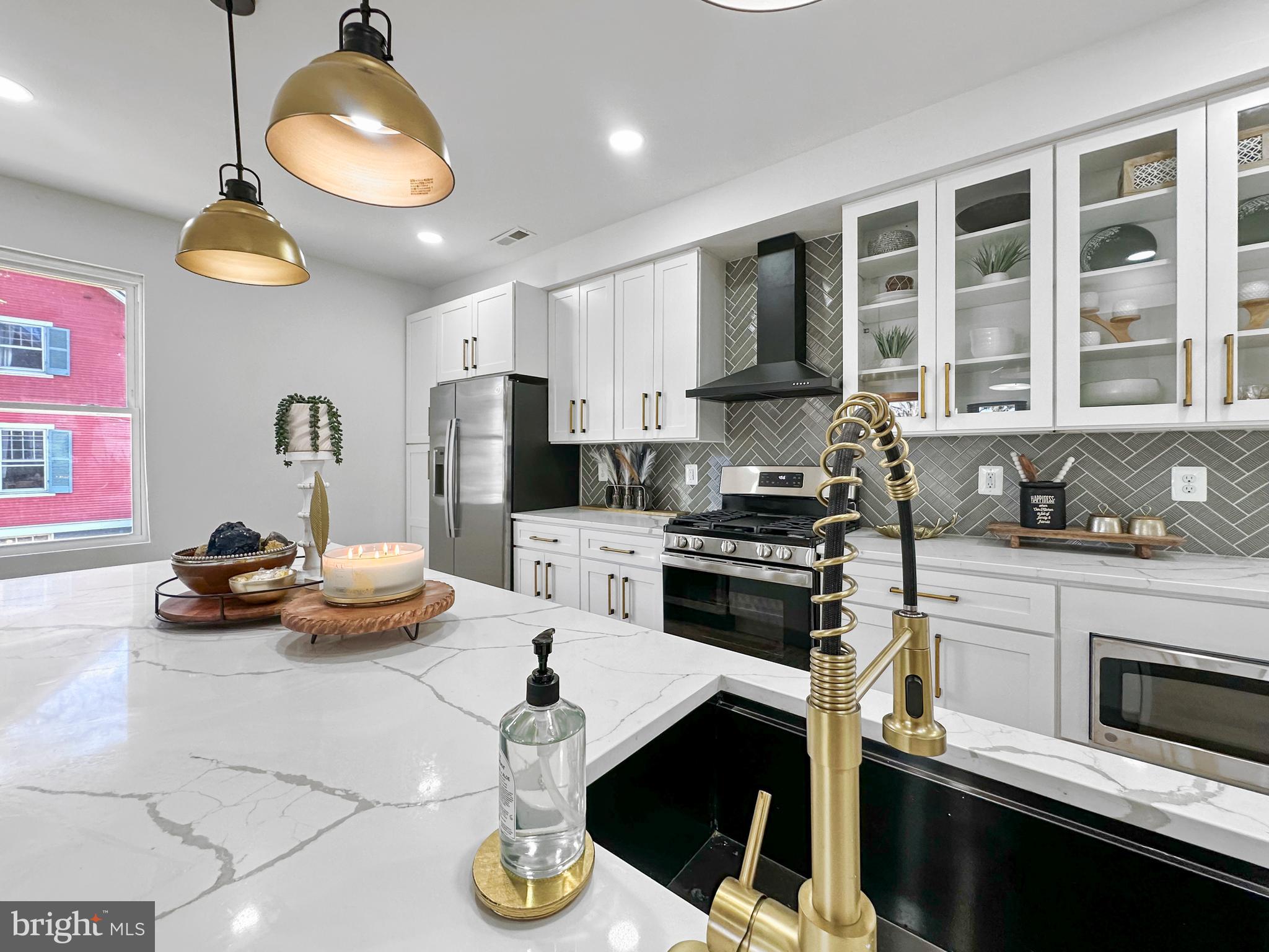 4309 Queensbury Road Riverdale, MD 20737 - Photo 22 of 63 a kitchen with a stove a refrigerator and a stove top oven
