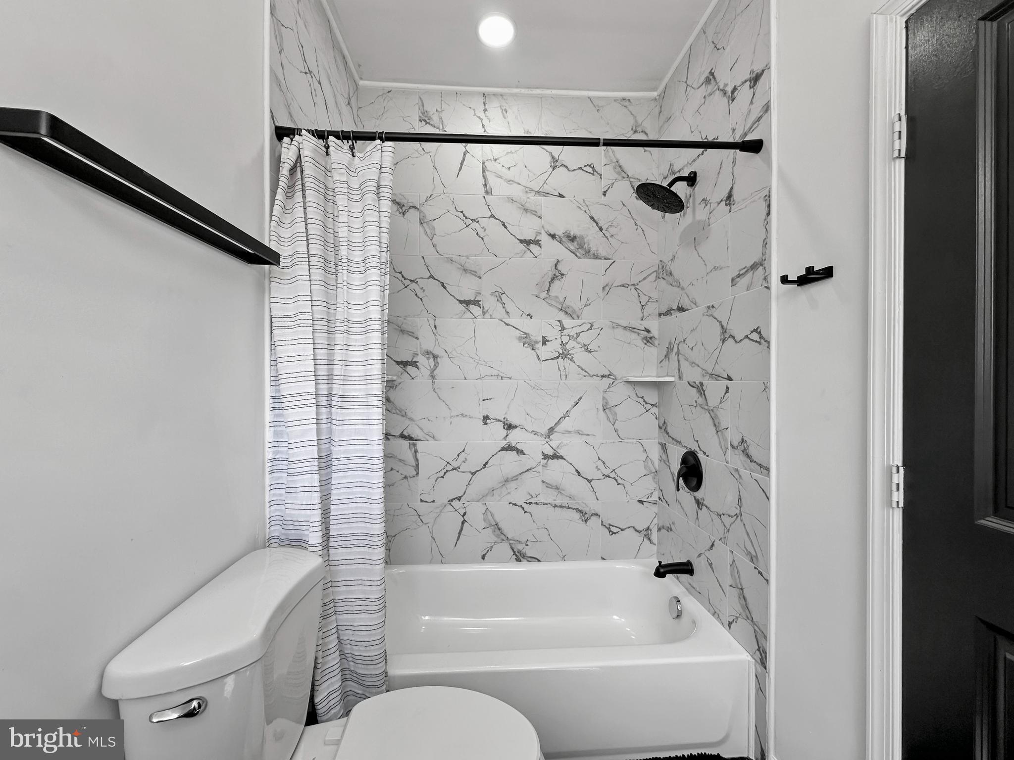 4309 Queensbury Road Riverdale, MD 20737 - Photo 26 of 63 a bathroom with a toilet and a bathtub