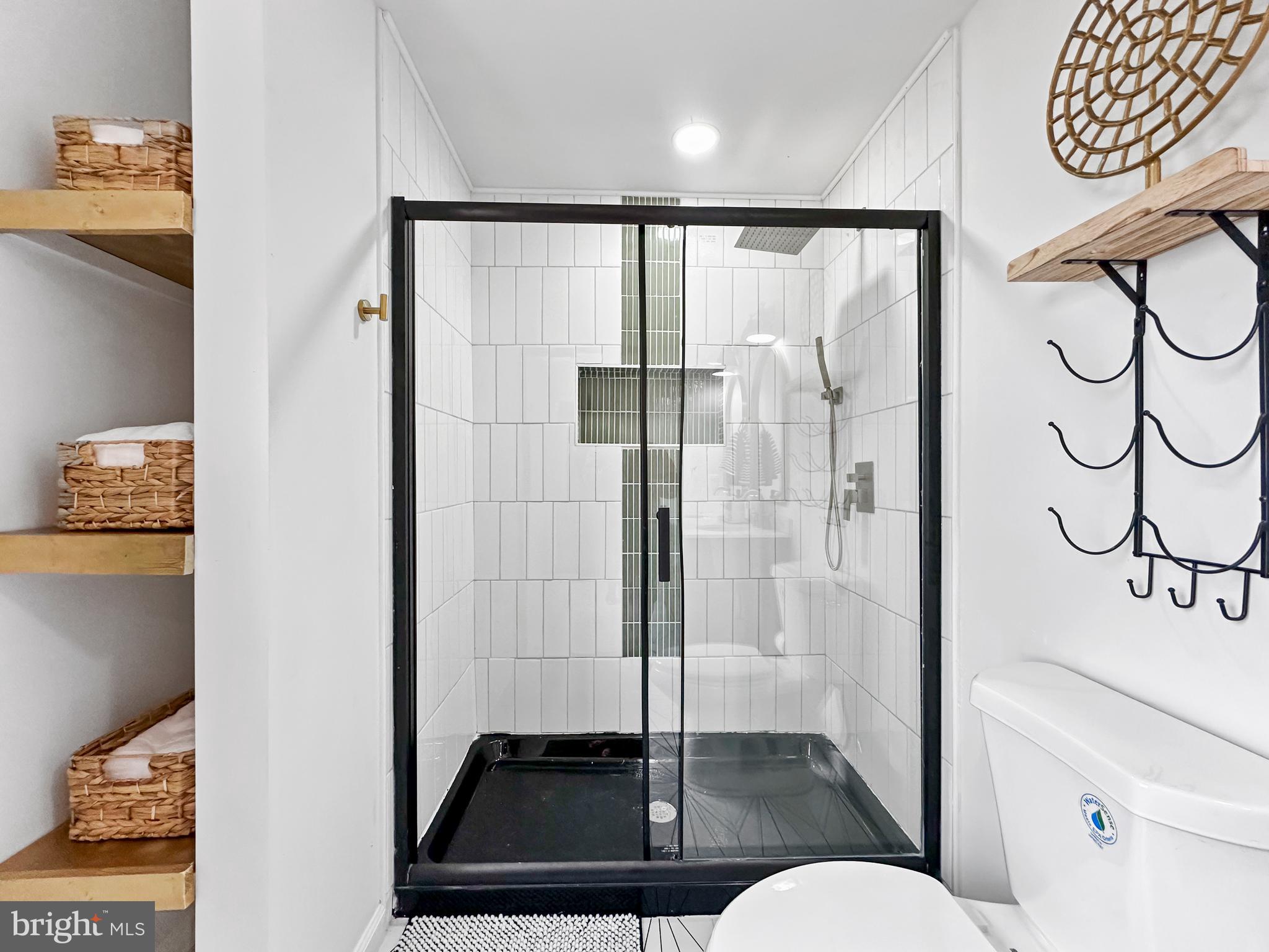 4309 Queensbury Road Riverdale, MD 20737 - Photo 37 of 63 a bathroom with a shower and a mirror