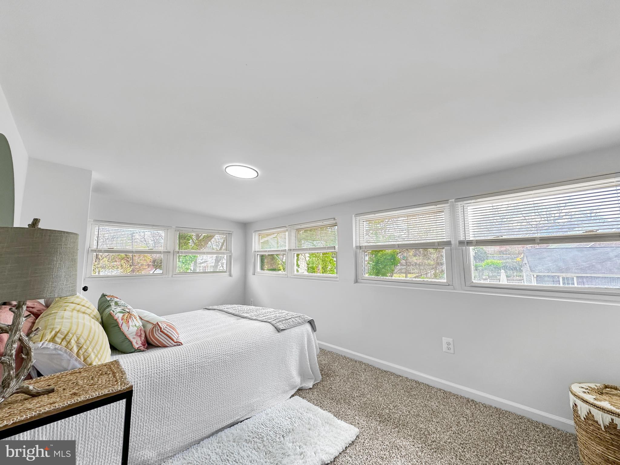 4309 Queensbury Road Riverdale, MD 20737 - Photo 40 of 63 a spacious bedroom with a bed and a couch