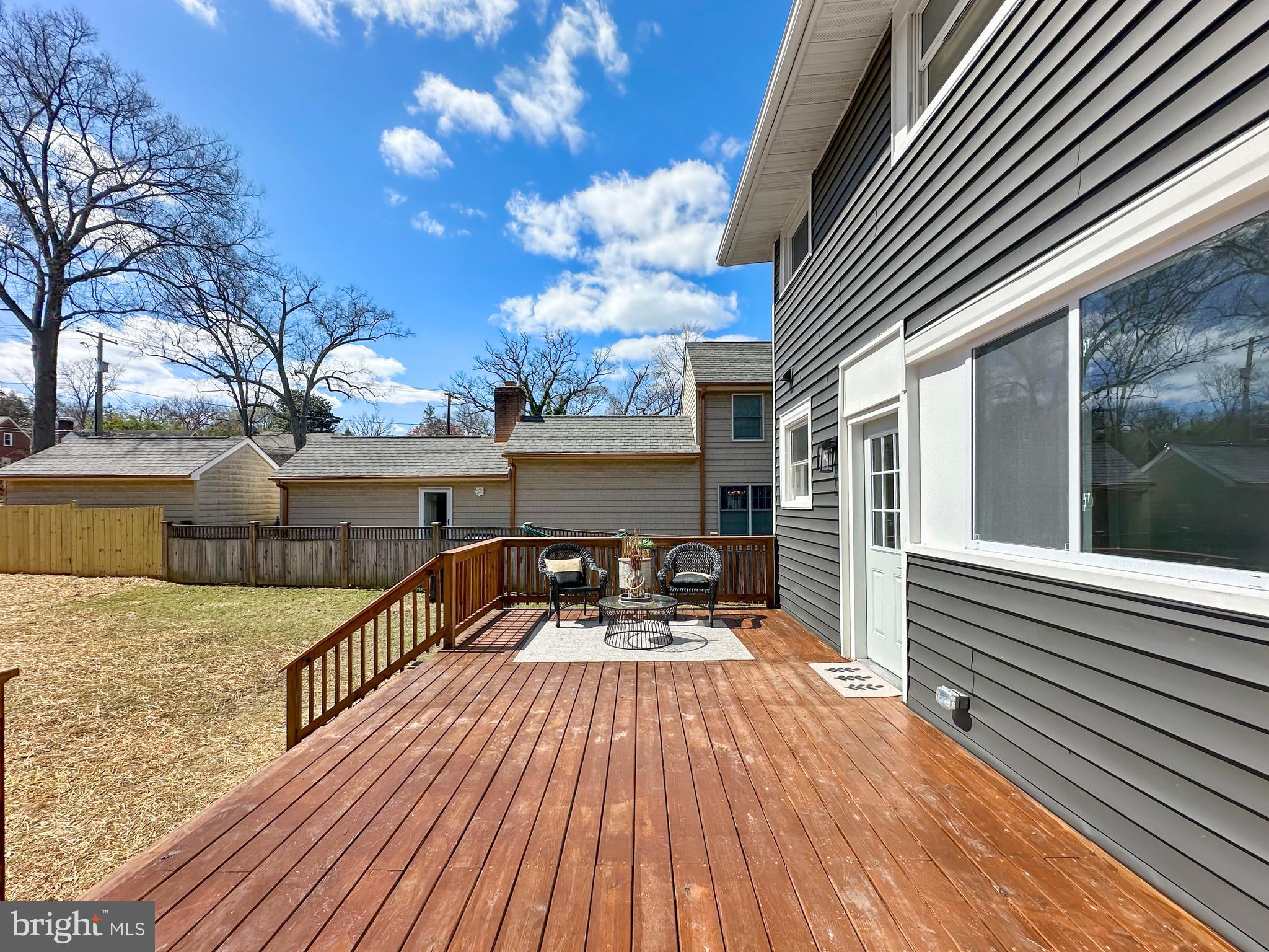 4309 Queensbury Road Riverdale, MD 20737 - Photo 58 of 63 a balcony with wooden floor table and chairs