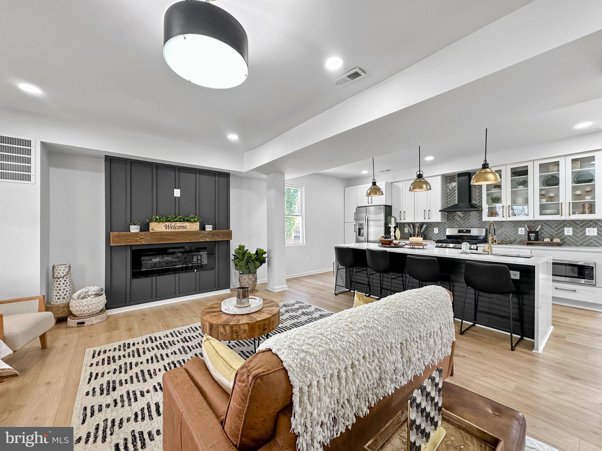 4309 Queensbury Road Riverdale, MD 20737 - Photo 8 of 63 a living room with furniture a kitchen view and kitchen view