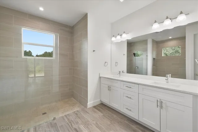 a bathroom with a shower sink and mirror