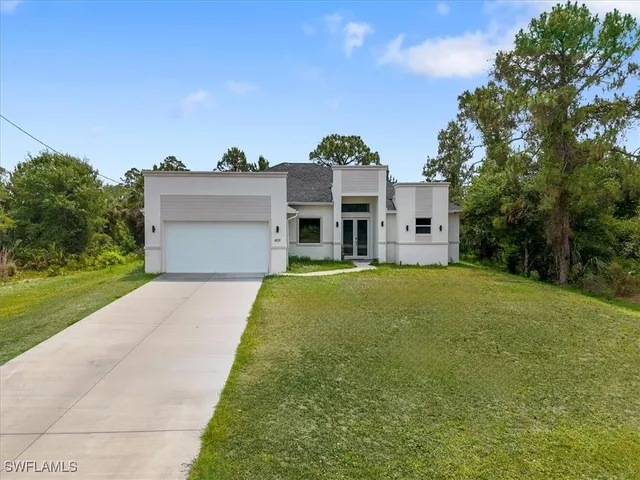 a front view of a house with a yard and garage