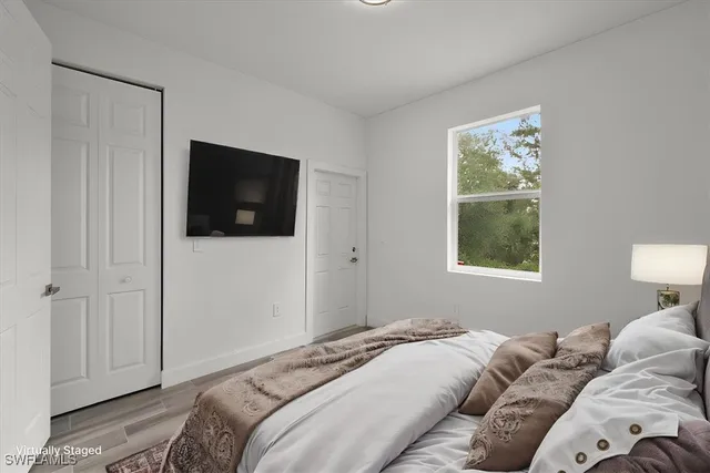 a bedroom with a bed and a television