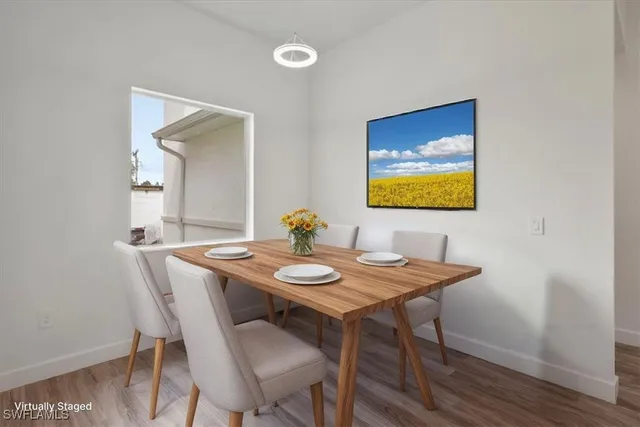 a view of a dining room with furniture and wooden floor