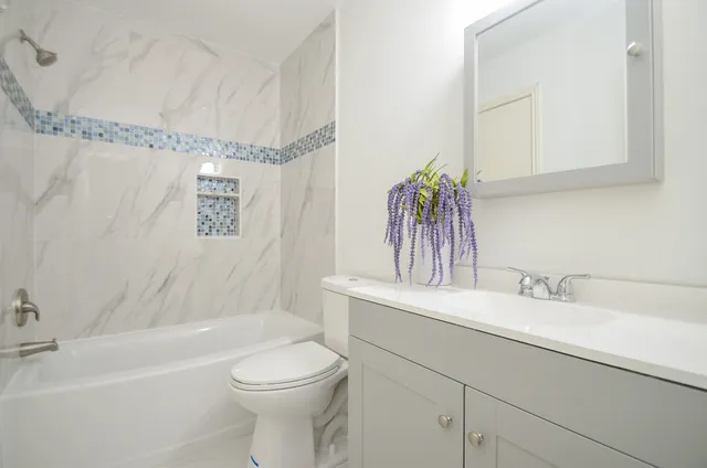 a bathroom with a bathtub and a shower