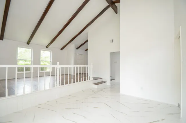 a view of staircase with white walls and a window