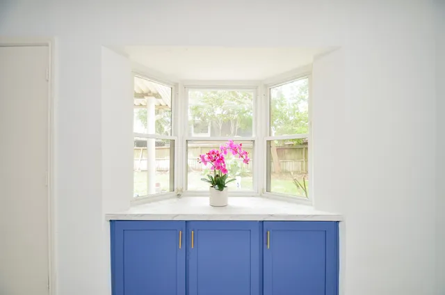 a kitchen with wooden cabinets and a stove top oven