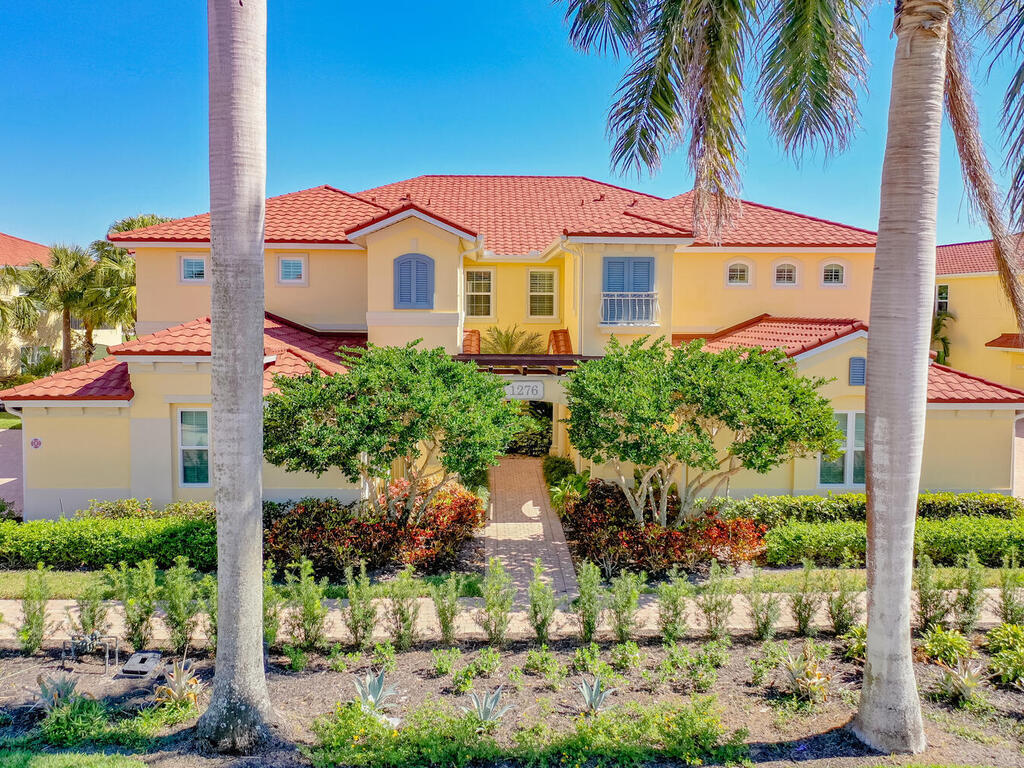 1276 Rialto Way, Unit 102 Naples, FL 34114 - Photo 1 of 37 front view of a house with a yard
