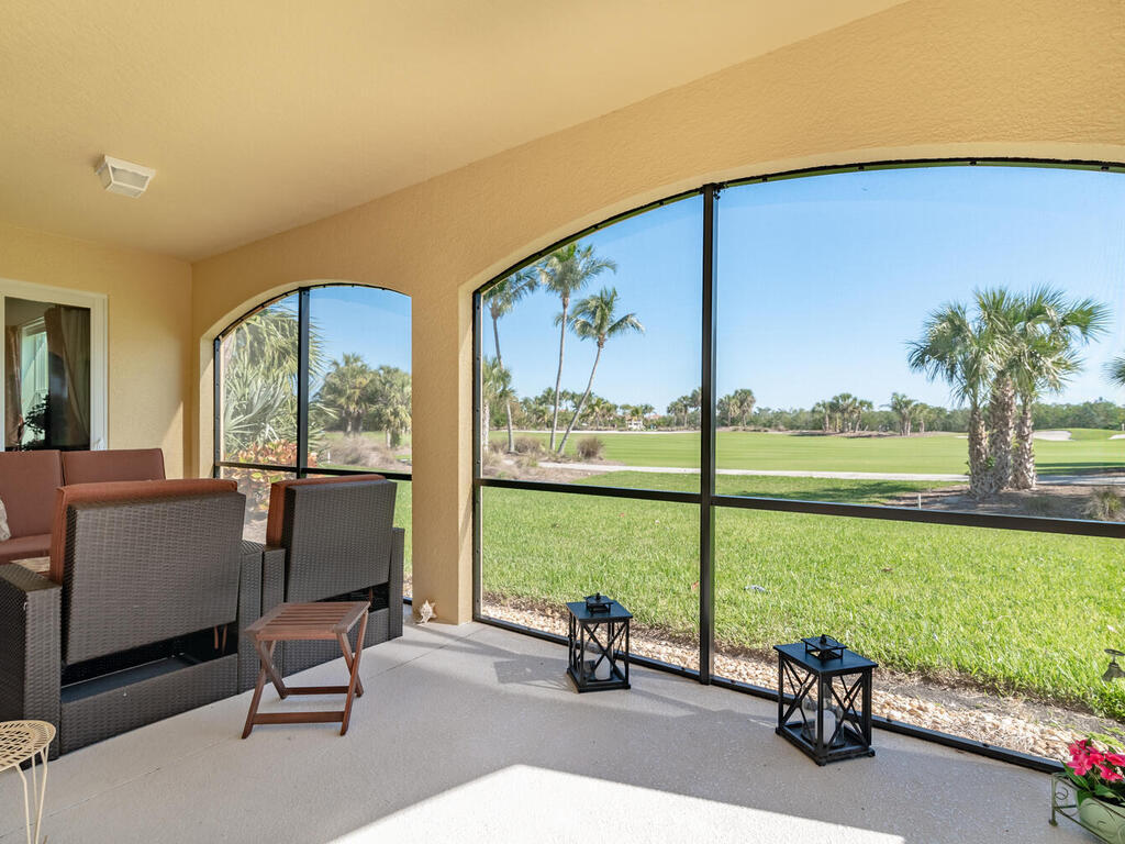 1276 Rialto Way, Unit 102 Naples, FL 34114 - Photo 13 of 37 a view of a room with gym equipment and large windows