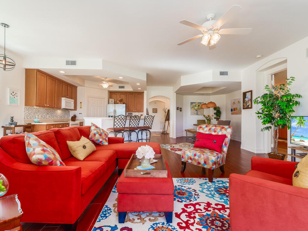 1276 Rialto Way, Unit 102 Naples, FL 34114 - Photo 14 of 37 a living room with furniture kitchen view and a chandelier