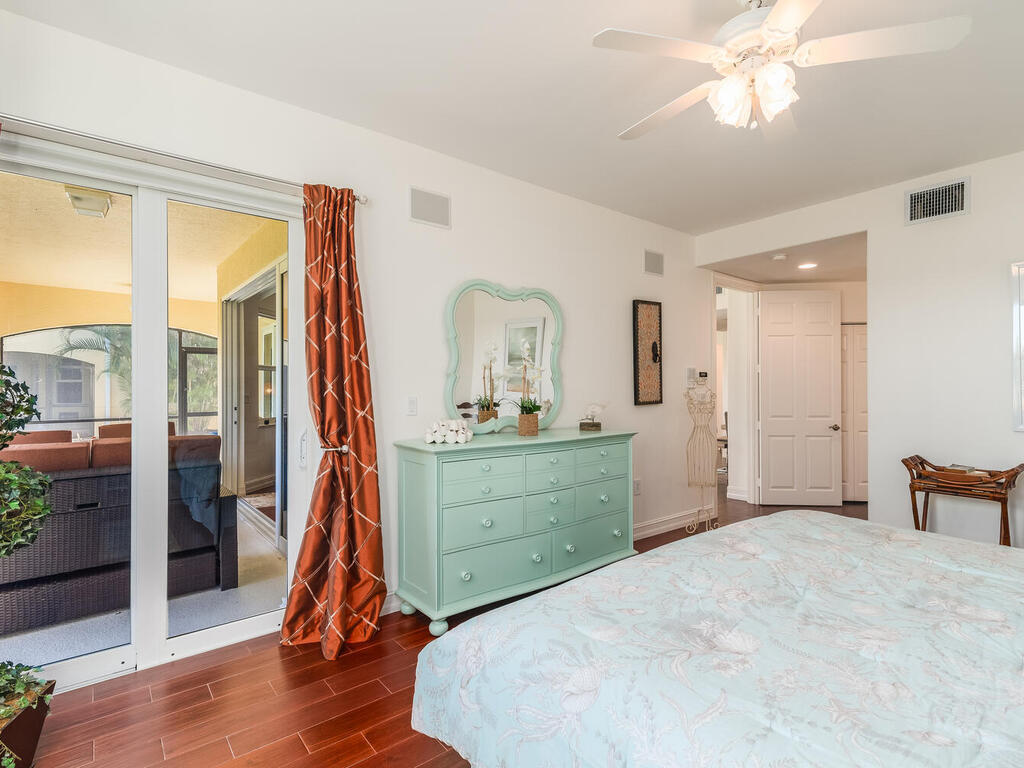 1276 Rialto Way, Unit 102 Naples, FL 34114 - Photo 17 of 37 a bed room with a bed and a mirror