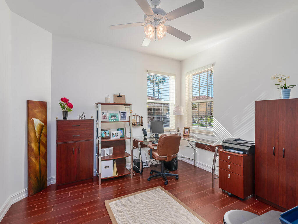 1276 Rialto Way, Unit 102 Naples, FL 34114 - Photo 19 of 37 a view of a workspace with furniture and a window