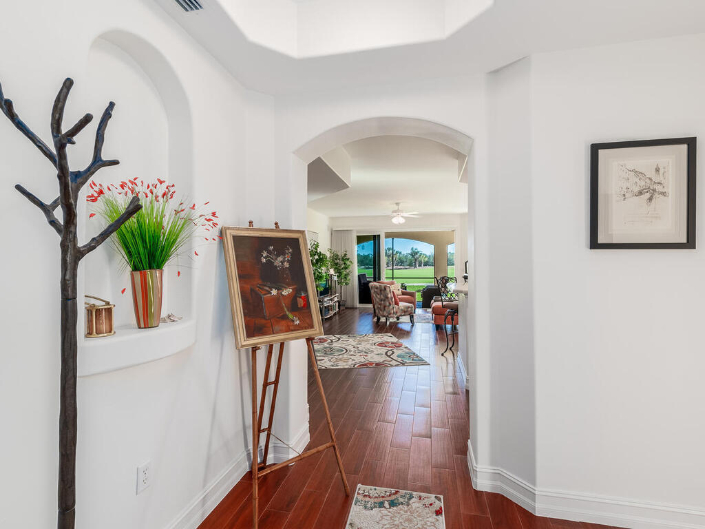 1276 Rialto Way, Unit 102 Naples, FL 34114 - Photo 2 of 37 a view of living room filled with furniture and a potted plant