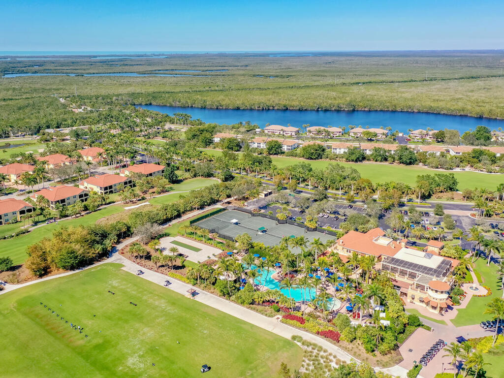 1276 Rialto Way, Unit 102 Naples, FL 34114 - Photo 28 of 37 a view of a city with an ocean