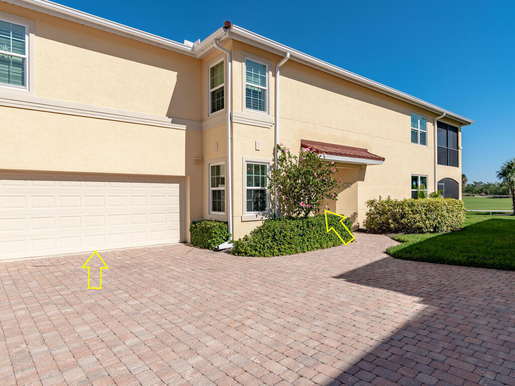 1276 Rialto Way, Unit 102 Naples, FL 34114 - Photo 31 of 37 a front view of a house with a garden