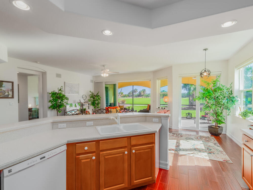 1276 Rialto Way, Unit 102 Naples, FL 34114 - Photo 6 of 37 a kitchen with stainless steel appliances granite countertop a stove a sink and a potted plant
