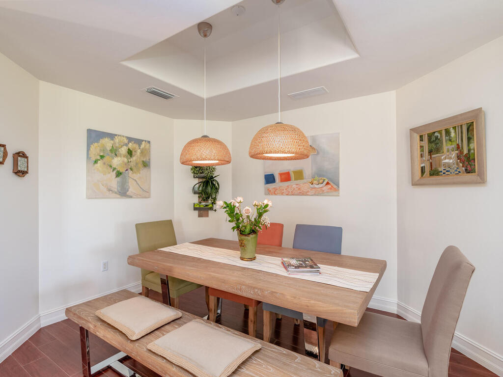 1276 Rialto Way, Unit 102 Naples, FL 34114 - Photo 8 of 37 a view of a dining room with furniture