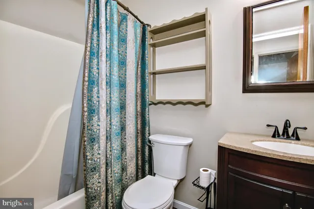 a bathroom with a toilet a sink and a mirror