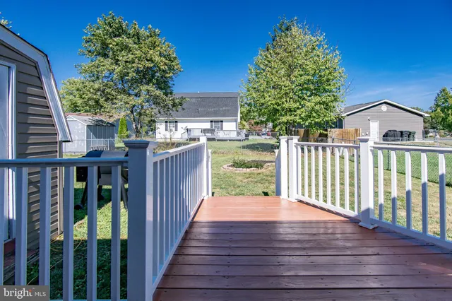 a view of backyard with deck and wooden floor