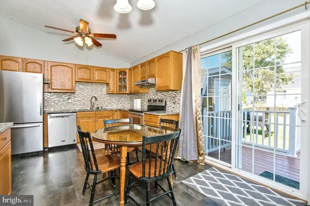 a kitchen with a table chairs refrigerator and cabinets