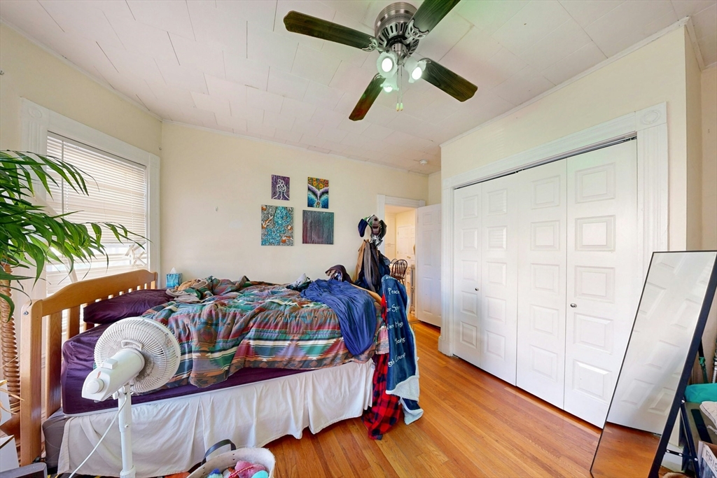 58 Dearborn Street Medford, MA 02155 - Photo 14 of 38 a bedroom with furniture and wooden floor