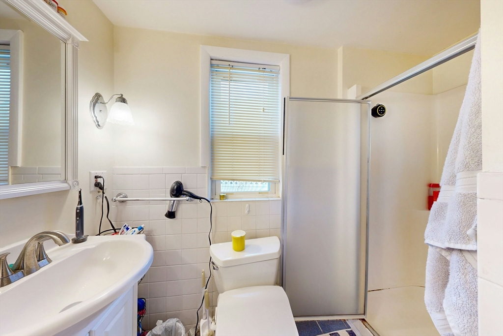 58 Dearborn Street Medford, MA 02155 - Photo 16 of 38 a bathroom with a sink a toilet and shower