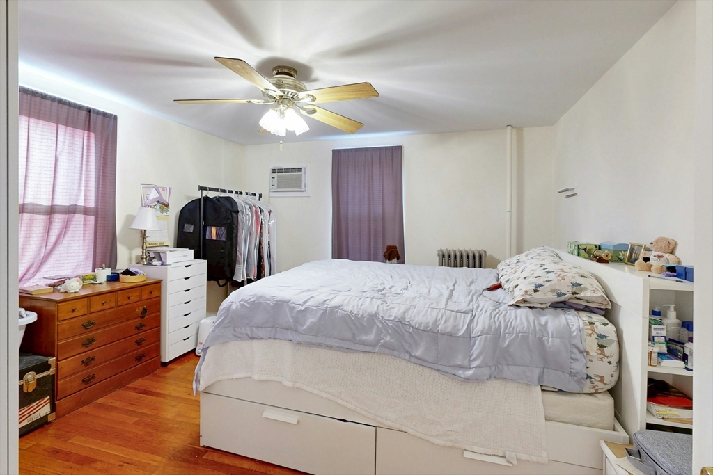 58 Dearborn Street Medford, MA 02155 - Photo 21 of 38 a bedroom with a bed and a chandelier