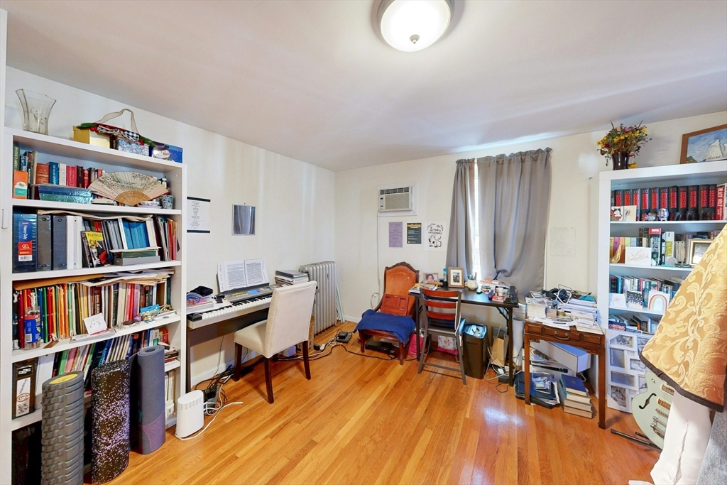 58 Dearborn Street Medford, MA 02155 - Photo 25 of 38 a living room with furniture and a book shelf