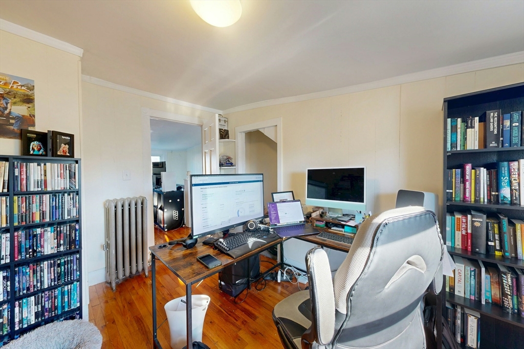 58 Dearborn Street Medford, MA 02155 - Photo 29 of 38 a view of a livingroom with workspace and a bookshelf